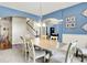 Elegant dining room with a large table, chandelier, and blue accent wall with decor at 1808 Woodfield Dr, Greenwood, IN 46143
