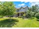 Beautiful two-story home featuring brick and siding exterior, lush lawn, and mature trees at 1808 Woodfield Dr, Greenwood, IN 46143