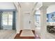 Spacious foyer with hardwood floors, white trim, and views into the adjacent dining and living rooms at 1808 Woodfield Dr, Greenwood, IN 46143