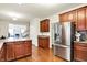Open kitchen features cherry cabinets, stainless steel appliances, and hardwood floors at 1808 Woodfield Dr, Greenwood, IN 46143
