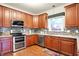 This kitchen features stainless steel appliances, granite countertops, and ample cabinet space at 1808 Woodfield Dr, Greenwood, IN 46143