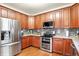 This open kitchen features stainless steel appliances, hardwood floors, and granite countertops at 1808 Woodfield Dr, Greenwood, IN 46143