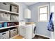 Well-organized laundry room with storage shelves, washer, and dryer at 1808 Woodfield Dr, Greenwood, IN 46143