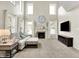Bright living room boasts tall ceilings, a fireplace, large windows with white curtains, and light-colored carpet at 1808 Woodfield Dr, Greenwood, IN 46143