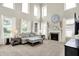 Bright living room features soaring ceilings, fireplace, large windows with coverings, and neutral decor at 1808 Woodfield Dr, Greenwood, IN 46143
