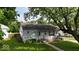 Charming single-story home with a well-maintained lawn and mature trees providing shade at 1837 Bauer Rd, Indianapolis, IN 46218