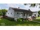 Cozy one-story home featuring a quaint porch and lush green lawn, nestled in a quiet neighborhood at 1837 Bauer Rd, Indianapolis, IN 46218