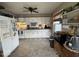 Classic kitchen with white cabinets, modern appliances, and a ceiling fan at 1837 Bauer Rd, Indianapolis, IN 46218