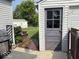 Side exterior view of a detached garage; lovely pathway to the backyard and rear of the main house at 1837 Bauer Rd, Indianapolis, IN 46218