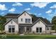 Charming two-story home featuring stone accents, a covered entryway, and vertical siding detail at 19602 Wood Farm Pl, Westfield, IN 46074