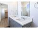 Bathroom featuring gray vanity, double sinks and view into walk-in closet at 2051-2053 Columbia Ave, Indianapolis, IN 46202