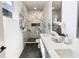 Elegant bathroom featuring a double vanity and marble tiled shower with glass door at 2051-2053 Columbia Ave, Indianapolis, IN 46202