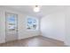 A bright bedroom with wood-look floors and an exterior door at 2051-2053 Columbia Ave, Indianapolis, IN 46202