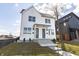 Charming new construction duplex with white siding, a manicured lawn, and concrete steps leading to the front doors at 2051-2053 Columbia Ave, Indianapolis, IN 46202