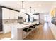 Modern kitchen with white cabinets, a large island with seating, and stainless steel appliances at 2051-2053 Columbia Ave, Indianapolis, IN 46202