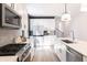 Modern kitchen featuring stainless steel appliances, white cabinetry, and bright quartz countertops at 2051-2053 Columbia Ave, Indianapolis, IN 46202