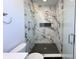 Shower featuring marble tile, glass door and black herringbone tile floor at 2051-2053 Columbia Ave, Indianapolis, IN 46202