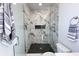 Walk in shower with rain shower head, black herringbone floor, and marble tiling at 2051-2053 Columbia Ave, Indianapolis, IN 46202