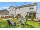 Inviting backyard featuring a fire pit and comfortable seating, perfect for enjoying outdoor gatherings and relaxation at 210 Lynnette Way, Cumberland, IN 46229
