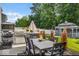 Outdoor dining area with grill and gazebo, set within a serene backyard landscape with lush greenery and seating at 210 Lynnette Way, Cumberland, IN 46229