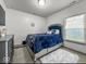 Cozy bedroom with soft carpeting, natural light, and a stylish blue bedframe, creating a relaxing atmosphere at 210 Lynnette Way, Cumberland, IN 46229