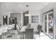 Bright dining area featuring stylish pendant lighting, a spacious dining table, and easy access to kitchen and living areas at 210 Lynnette Way, Cumberland, IN 46229