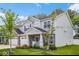 A two-story home with stone accents, a two-car garage, and lovely landscaping create a welcoming curb appeal at 210 Lynnette Way, Cumberland, IN 46229