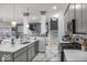 Spacious kitchen showcases grey cabinets, stainless steel appliances, a large island, and an open floor plan at 210 Lynnette Way, Cumberland, IN 46229