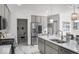 Beautiful kitchen boasts grey cabinets, stainless appliances, white countertops, and modern fixtures at 210 Lynnette Way, Cumberland, IN 46229