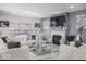 Elegant living room with white tufted sofas, a fireplace, marble floors, and ample natural light at 210 Lynnette Way, Cumberland, IN 46229