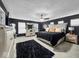 Stylish main bedroom featuring dark walls, plush carpeting, and ample natural light, a luxurious retreat within the home at 210 Lynnette Way, Cumberland, IN 46229