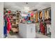 Organized walk-in closet with custom shelving, a chandelier, and ample storage space for clothing and accessories at 210 Lynnette Way, Cumberland, IN 46229