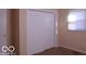 This bedroom features neutral walls, a window, and a closet with sliding doors at 2250 N Goodlet Ave, Indianapolis, IN 46222