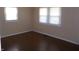 This bright bedroom has hardwood floors, neutral walls, and bright windows at 2250 N Goodlet Ave, Indianapolis, IN 46222