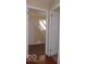 Hallway with stairway access and neutral paint, offering a glimpse of the home's layout at 2250 N Goodlet Ave, Indianapolis, IN 46222