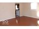 Bright living room with hardwood floors and a view into the kitchen area at 2250 N Goodlet Ave, Indianapolis, IN 46222