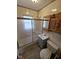Bathroom featuring a shower with sliding glass doors, a wooden vanity and tiled walls at 2411 Harlan St, Indianapolis, IN 46203