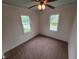 Cozy bedroom featuring two windows offering natural light and a classic ceiling fan at 2411 Harlan St, Indianapolis, IN 46203
