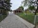 Charming brick home featuring a gated driveway and a well-manicured front yard at 2411 Harlan St, Indianapolis, IN 46203