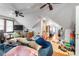 Expansive attic space featuring wood floors, ceiling fans, and natural light from windows at 3018 S Anthony Blvd, Fort Wayne, IN 46806