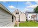 Backyard view of a white two-story home and detached one car garage under a blue sky at 3018 S Anthony Blvd, Fort Wayne, IN 46806