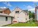 A two-story house with vinyl siding, green grass, and a detached one car garage at 3018 S Anthony Blvd, Fort Wayne, IN 46806