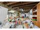 Unfinished basement with concrete floor and exposed ductwork is cluttered with boxes, toys, and containers at 3018 S Anthony Blvd, Fort Wayne, IN 46806
