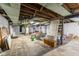 Unfinished basement featuring concrete floor, exposed duct work, and hot water heater at 3018 S Anthony Blvd, Fort Wayne, IN 46806