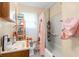 Cozy bathroom featuring a tub, shower, sink, and shelving for storage at 3018 S Anthony Blvd, Fort Wayne, IN 46806