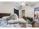 Comfortable bedroom featuring a ceiling fan, wood floors, and a closet for storage at 3018 S Anthony Blvd, Fort Wayne, IN 46806