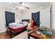 This bedroom features a ceiling fan, wood floors, and natural light from the window at 3018 S Anthony Blvd, Fort Wayne, IN 46806