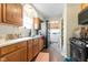 Functional kitchen with wood cabinetry, stainless steel appliances, and access to a laundry area at 3018 S Anthony Blvd, Fort Wayne, IN 46806