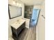 Stylish bathroom with a modern vanity, a large mirror, and wood-look flooring at 3103 Keswick Rd, Indianapolis, IN 46222