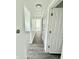 Hallway with updated floors and neutral walls at 3103 Keswick Rd, Indianapolis, IN 46222